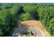 An aerial view of a vacant lot next to a wooded area, near a cul-de-sac at 10607 Audubon Ridge Dr # 27, Cornelius, NC 28031