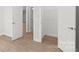 Simple bedroom with light walls, hardwood floors and a closet at 10607 Audubon Ridge Dr # 27, Cornelius, NC 28031