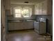 Kitchen with white cabinets, double sink, and electric range at 518 Williams Ave, Albemarle, NC 28001