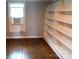 Bedroom with hardwood floors, built-in shelving, and window at 518 Williams Ave, Albemarle, NC 28001