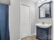 Clean bathroom with a navy vanity, white sink, and shower/tub at 806 Lee St, Kings Mountain, NC 28086