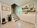 Bright stairwell with gray carpeting and white brick accent wall at 469 Radio Rd, Taylorsville, NC 28681