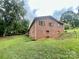 Brick home with green lawn and mature trees at 469 Radio Rd, Taylorsville, NC 28681