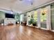 Living room with hardwood floors, large windows, and TV at 469 Radio Rd, Taylorsville, NC 28681