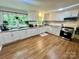 Kitchen with white cabinets, stainless steel appliances, and a window at 469 Radio Rd, Taylorsville, NC 28681