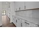 White kitchen cabinets with quartz countertops and herringbone backsplash at 297 Supernova Dr, York, SC 29745