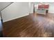 Spacious living area with hardwood floors and kitchen access at 3935 Sky Dr, Charlotte, NC 28226