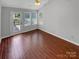 Bright sunroom with wood-look tile floor, access to backyard deck at 6614 Flat Creek Dr, Charlotte, NC 28277