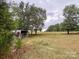 Open pasture with a rustic shed at 1470 River Hills Ct, Taylorsville, NC 28681