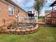 Brick home with a pond, deck, and storage building in the backyard at 1470 River Hills Ct, Taylorsville, NC 28681