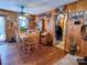Farmhouse style dining room with wood walls and a wooden table at 1470 River Hills Ct, Taylorsville, NC 28681