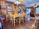 Bright dining room with wood walls and farmhouse table at 1470 River Hills Ct, Taylorsville, NC 28681
