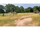 Gravel driveway leads to home with a metal gate and rustic shed in the background at 1470 River Hills Ct, Taylorsville, NC 28681