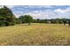 Open pasture with distant view of homes and trees at 1470 River Hills Ct, Taylorsville, NC 28681