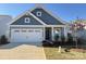 New two-story home with gray siding and a white garage door at 1035 Bull Dog Ln, Wingate, NC 28174