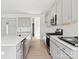 Modern kitchen with gray cabinets, quartz countertops, and stainless steel appliances at 1035 Bull Dog Ln, Wingate, NC 28174