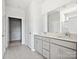 Bathroom boasts double vanity, gray cabinets, and walk-in shower at 1035 Bull Dog Ln, Wingate, NC 28174