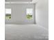 Spacious bedroom with neutral walls and carpet, featuring two large windows at 1035 Bull Dog Ln, Wingate, NC 28174