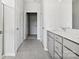 Double vanity bathroom with gray cabinets and access to a walk-in closet at 1035 Bull Dog Ln, Wingate, NC 28174