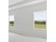 Well-lit bedroom with neutral walls and carpet, featuring two large windows with a view at 1035 Bull Dog Ln, Wingate, NC 28174