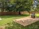 Brick patio with built-in grill and fenced yard at 115 Matthews Township Pkwy, Matthews, NC 28105