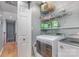 Convenient laundry room with washer, dryer, and shelving at 1432 Bedlington Dr, Charlotte, NC 28269