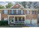 Brick two-story house with a front porch and a two-car garage at 1432 Bedlington Dr, Charlotte, NC 28269