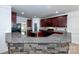 Kitchen features granite countertops, dark wood cabinets, and a stone breakfast bar at 1013 Taylor Glenn Ln, Indian Trail, NC 28079