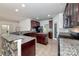 Modern kitchen with dark wood cabinets, granite counters, and an island at 1013 Taylor Glenn Ln, Indian Trail, NC 28079