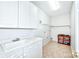 Laundry room with white cabinets and shelving at 1013 Taylor Glenn Ln, Indian Trail, NC 28079