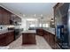 Open concept kitchen with granite counters, island, and stainless steel appliances at 1013 Taylor Glenn Ln, Indian Trail, NC 28079