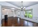 Spacious dining room featuring hardwood floors, chandelier, and large windows at 1013 Taylor Glenn Ln, Indian Trail, NC 28079