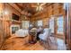 Wood-paneled office with fireplace, built-ins, and hardwood floors at 300 Eagle Bend Dr, Waxhaw, NC 28173