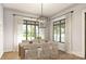 Formal dining room with hardwood floors, large windows, and a modern light fixture at 300 Spanish Oak Ln, Gastonia, NC 28056