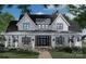 Two-story farmhouse with wrap-around porch, black windows, and white siding at 300 Spanish Oak Ln, Gastonia, NC 28056