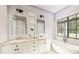 Elegant bathroom with double vanity, soaking tub, and large window at 300 Spanish Oak Ln, Gastonia, NC 28056