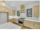 Modern kitchen with tan cabinets, marble countertops, and stainless steel appliances at 1106 Anniston Pl # 51, Indian Trail, NC 28079