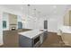 Open concept kitchen with large island and a view into the living room at 1106 Anniston Pl # 51, Indian Trail, NC 28079