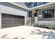 Two car garage with black door and light colored stone exterior at 1106 Anniston Pl # 51, Indian Trail, NC 28079