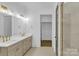 Modern bathroom with taupe cabinets, quartz countertops, and a walk-in closet at 1106 Anniston Pl # 51, Indian Trail, NC 28079
