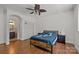 Charming bedroom with hardwood floors, en-suite bathroom, and ceiling fan at 7230 Timber Ridge Dr, Mint Hill, NC 28227