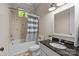 Bathroom with tub, shower, granite vanity and striped curtain at 7230 Timber Ridge Dr, Mint Hill, NC 28227
