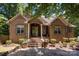 Brick home with stone accents, double door entry, and landscaping at 7230 Timber Ridge Dr, Mint Hill, NC 28227