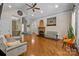 Spacious living room featuring hardwood floors, a fireplace, and ample natural light at 7230 Timber Ridge Dr, Mint Hill, NC 28227