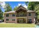 Two-story house with tan siding, a balcony, and a covered patio at 7230 Timber Ridge Dr, Mint Hill, NC 28227
