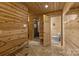 Rustic bathroom with wood walls, shower, toilet, and tile floor at 7230 Timber Ridge Dr, Mint Hill, NC 28227