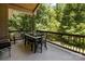Covered deck with wooded views and outdoor dining set at 7230 Timber Ridge Dr, Mint Hill, NC 28227