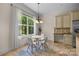 Bright breakfast nook with a table and chairs, offering a view of the backyard at 7230 Timber Ridge Dr, Mint Hill, NC 28227