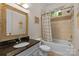 Bathroom with tub, shower, granite vanity and striped curtain at 7230 Timber Ridge Dr, Mint Hill, NC 28227