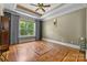 Spacious bedroom with hardwood floors and large window, offering natural light at 7230 Timber Ridge Dr, Mint Hill, NC 28227